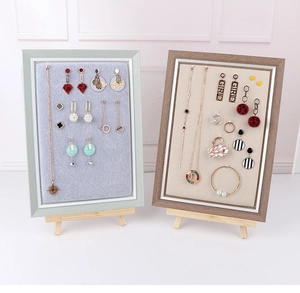 Close-up of wooden frame jewelry display boards with linen and velvet lining inserts