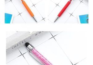 Close-up detail of metal crystal ballpoint pen with capacitive stylus tip and sparkling stones.