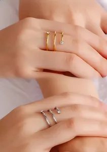 Detail of spiral multi-layer wrap ring with cubic zirconia in gold and silver finish