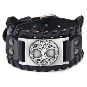 Detail of black leather bracelet featuring a silver Tree of Life Celtic knot metal charm