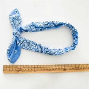 Elastic cotton headwrap with blue paisley print and rabbit ear bow design for women