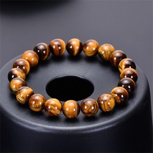 Macro shot of tiger eye stone beads showing natural cat-eye texture on display
