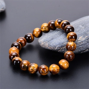Detailed close-up showing the cat-eye effect and polished texture of tiger eye beads