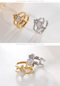 Close-up of double-layered heart and crown rings with white pavé cubic zirconia