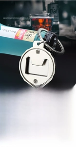 Macro view of a portable zinc alloy beer bottle opener keychain with a silver serrated design