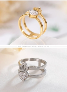 Detail of double-layer crown and heart rings with cubic zirconia in gold and silver