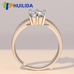Detail of rose gold ring with six-claw crown setting and adjustable open band design