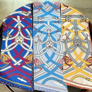 Three premium silk scarves with horse harness patterns in navy, blue and yellow