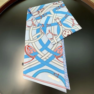 Detail of silk twill scarf showing equestrian belt prints and luxury fabric texture