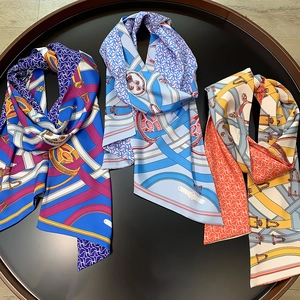Detail of luxury silk twill skinny scarves with horse bit and belt print in three colors