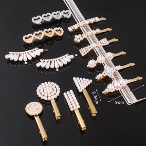 Detailed view of pearl hair clips in various shapes with dimensions 2.5cm by 9cm