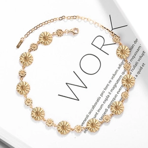 Detailed macro view of S925 sterling silver gold-plated sunflower link chain with lobster clasp