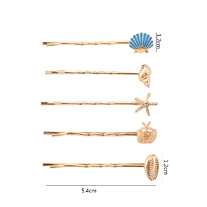 Golden ocean series hair clips with starfish and seashell charms on white background