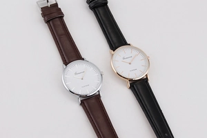 Detail view of ultra-thin minimalist quartz watches with brown and black leather straps