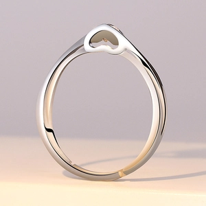 Detailed side view of silver six-prong ring featuring an elegant hollow heart and zircon