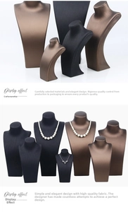 Close-up of necklace display stands in black and bronze with elegant pearl jewelry