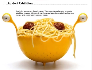 Detail view of yellow monster-shaped pasta strainer with creative eye-shaped handles