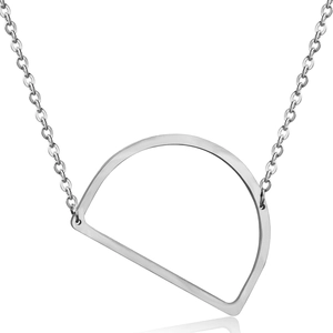 Detail view of a silver geometric D-shaped pendant on a fine link chain over a white background