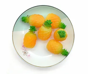 Set of six realistic PVC pineapple charms with silver metal rings in a white bowl