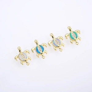 Detailed view of four golden turtle connectors with opal inlay on white background