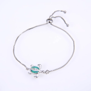 Detail of silver turtle bracelet with green opal inlay and adjustable sliding clasp closure