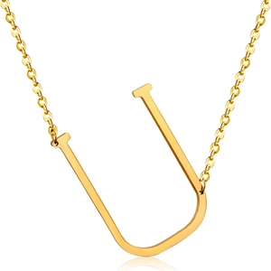 Macro detail of 18K gold plated stainless steel initial U pendant on a link chain