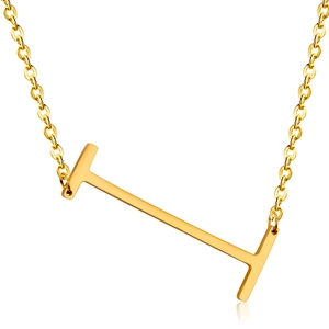 Close-up of golden letter H pendant necklace with detailed polished metal finish