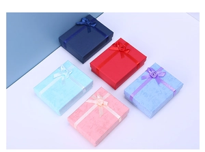 Top view of multi-color jewelry gift boxes with elegant ribbon bows and floral accents