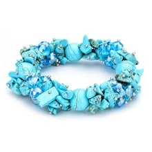 Detail of blue turquoise beaded bracelet with silver spacers in bohemian style