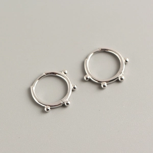 Close-up of minimalist S925 sterling silver hoop earrings with small beaded details