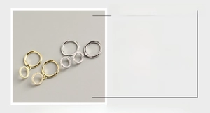 Detailed view of S925 silver hoop earrings with diamond charms in gold and silver finishes