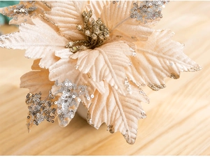 Close-up of a 25cm champagne sequined velvet Christmas flower with gold glitter details
