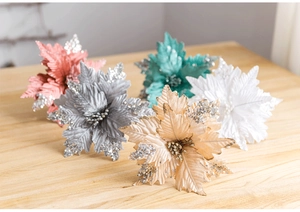 Detail of 25cm sequined velvet Christmas flowers in multiple colors on wood background