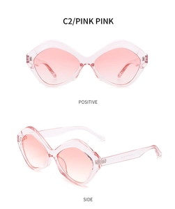 Detailed view of pink irregular geometric sunglasses with gradient lenses and clear frames