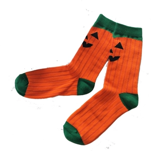 Cartoon Halloween crew socks with orange pumpkin pattern and green contrast accents