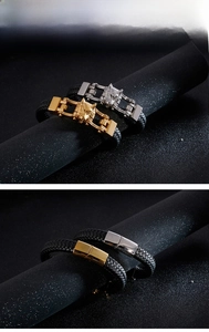 Macro detail of men's braided leather bracelet featuring a textured gold wolf head clasp