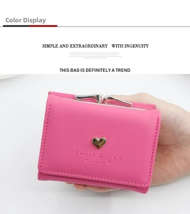 Macro view of a rose pink trifold wallet with gold heart charm and fine PU leather texture