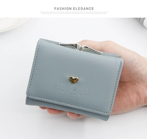 Close-up of light blue leather wallet with heart metal buckle and Sweet Dream print
