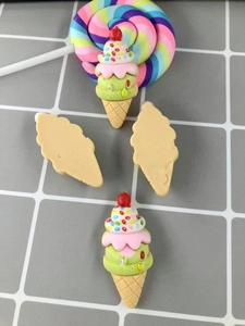 Macro detail of resin ice cream charms with red cherry for DIY phone case crafts