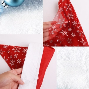 Detail of red Christmas hat with silver snowflakes showing double-layer fabric and soft plush
