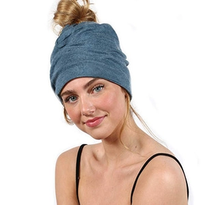 Close-up of blue chunky knit headband featuring a crossover twist design for winter