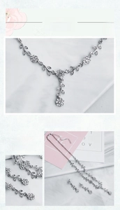 Detailed view of silver flower necklace and earrings set with sparkling white rhinestones