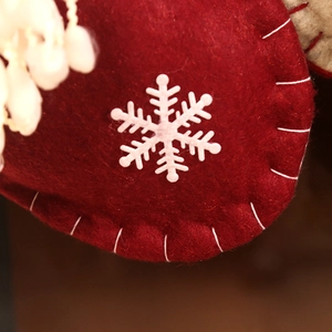 Classic red felt Christmas stocking with white snowflake patch and handcrafted stitching