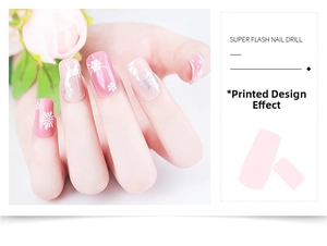 Detailed view of winter snowflake and silver reindeer patterns printed on pink manicured nails