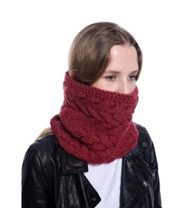 Detail eines roten Strickschals mit Zopfmuster, der die dicke Garntextur deutlich zeigt