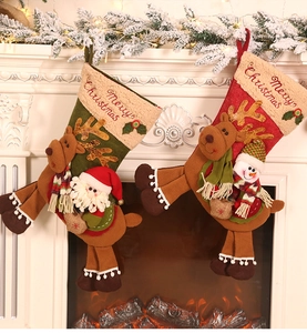 Detailed close-up of 3D Santa and Snowman embroidery on plush Christmas stockings