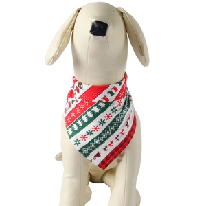 Close-up of red and green Christmas pet bandana with snowflake patterns on a dog model