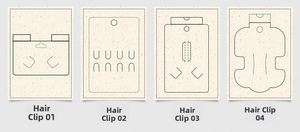 Detail view of four beige paper cardstock holders for hair clips with custom cutouts