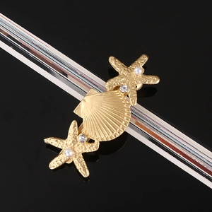 Detail of golden starfish and seashell hair clip with pearls and sparkling rhinestones