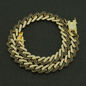 Detailed view of 13mm gold Cuban link chain with alternating clear and black rhinestones